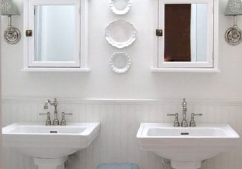 A Luxe White Bathroom With Pedestal Sinks